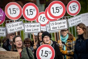 Activists in Berlin stood with signs calling for limiting global warming